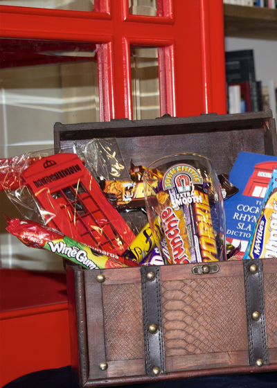 Multiple gift baskets from The Hamlet British store arranged together, each containing British‑themed snacks and goodies