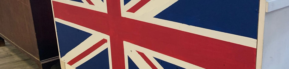 Close‑up of a large Union Jack painted panel inside The Hamlet British store